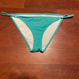 Women’s urban outfitters out from under teal bikini bottoms.